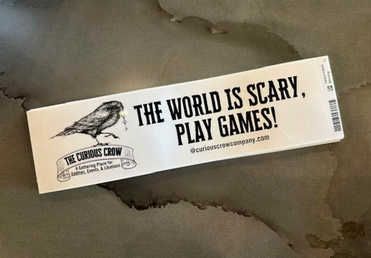 white background bumper sticker that reads "The world is scary, play games!" with our logo and website. 